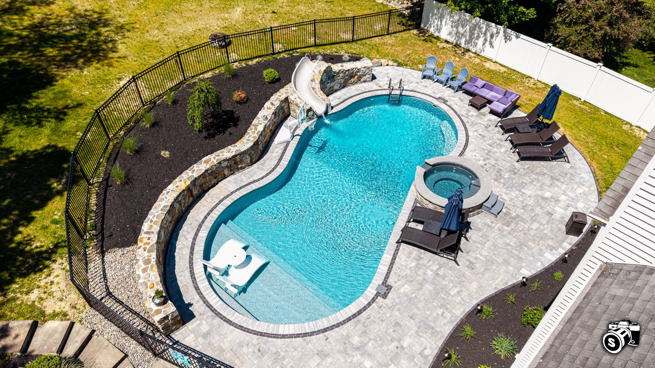 Aerial of a freeform in-ground pool with spa