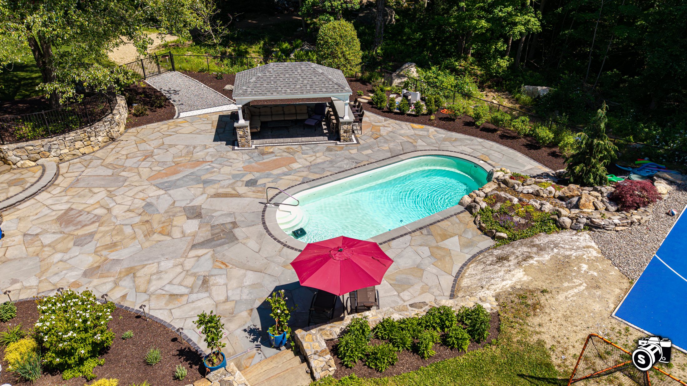 Flagstone patio surrounding an in-ground pool