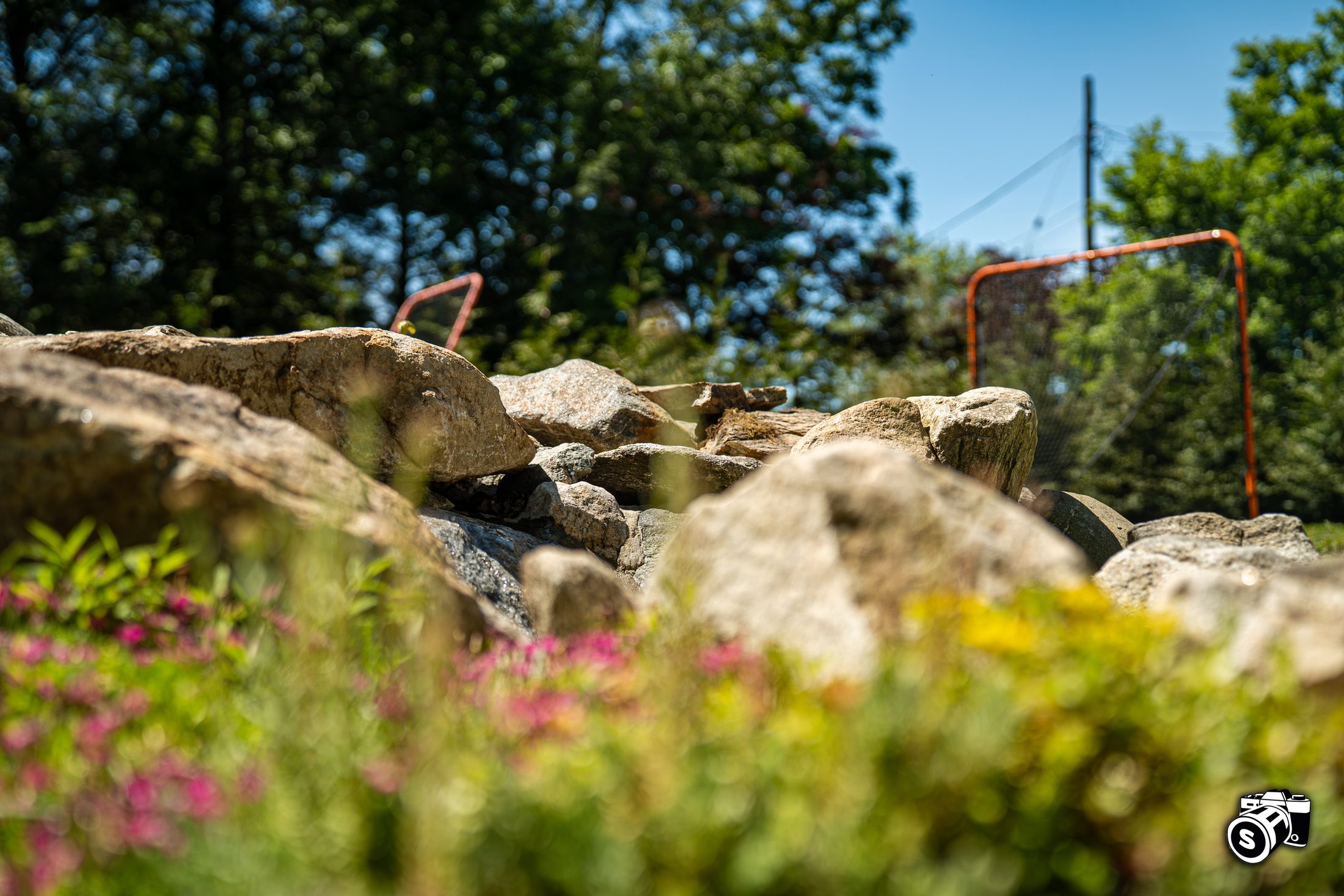 Boulder retaining wall with planted garden bed