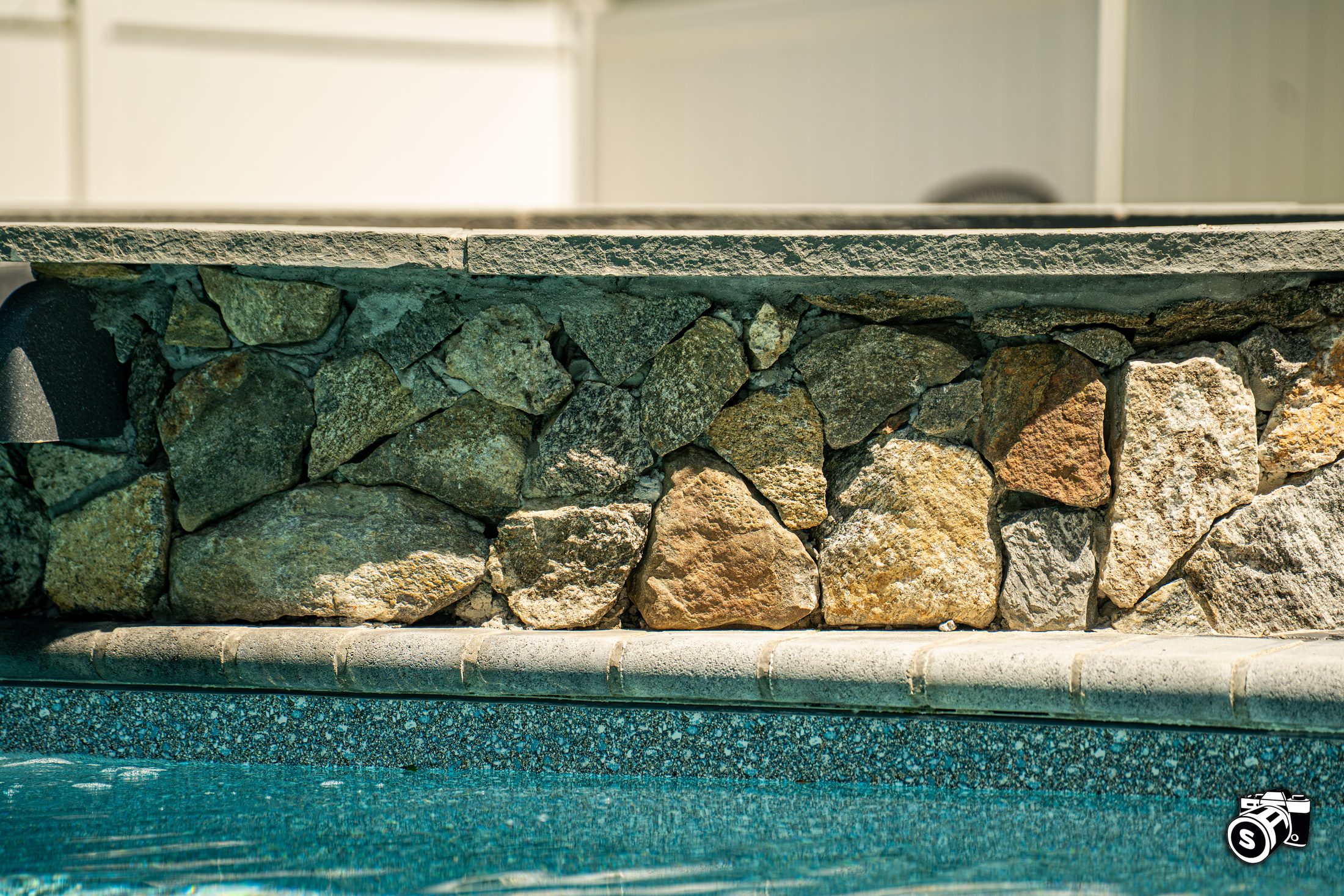 Natural rock waterfall spilling into a pool